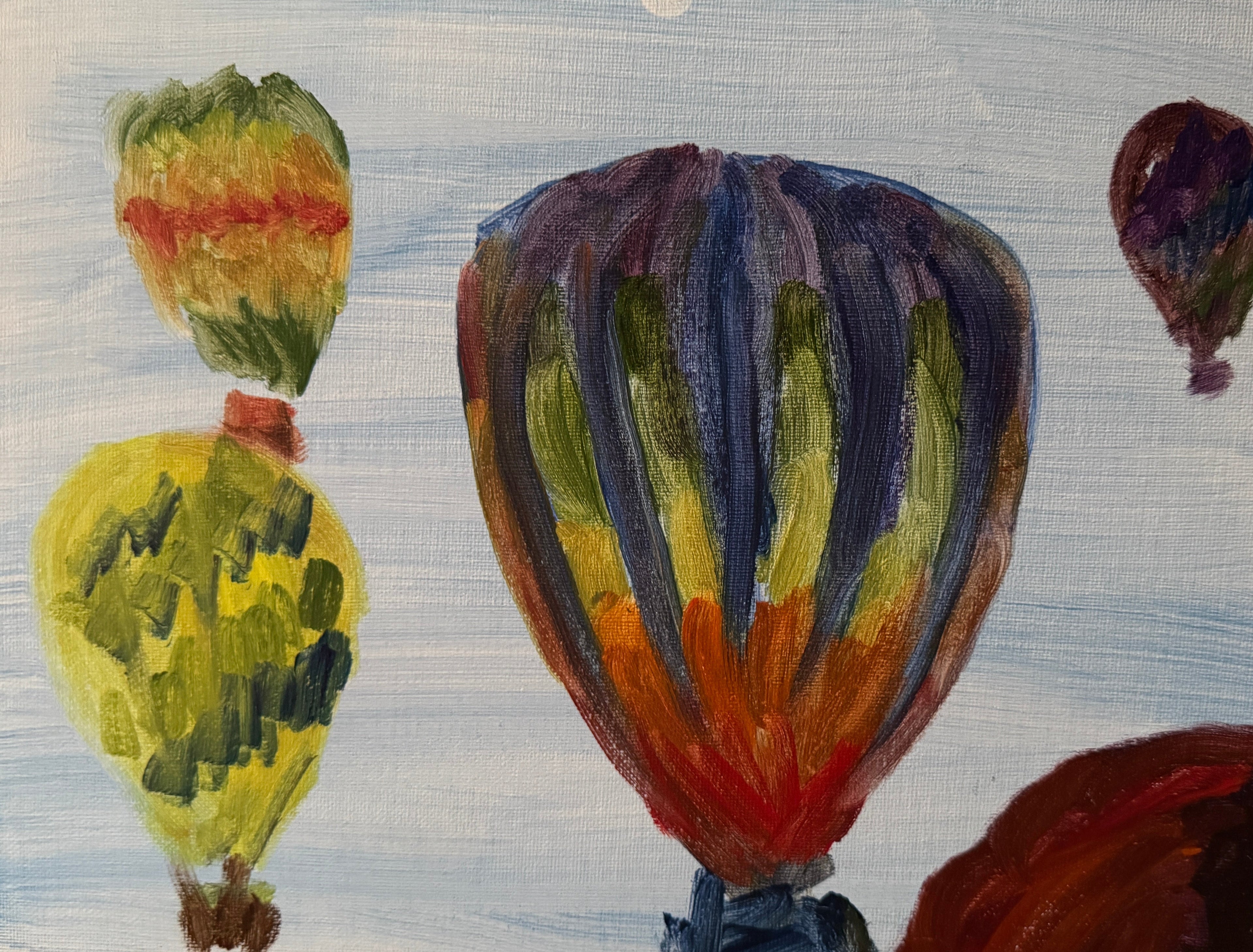 Painting of colorful hot air balloons on a textured surface