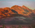 Small painting of a mountain landscape on a textured surface