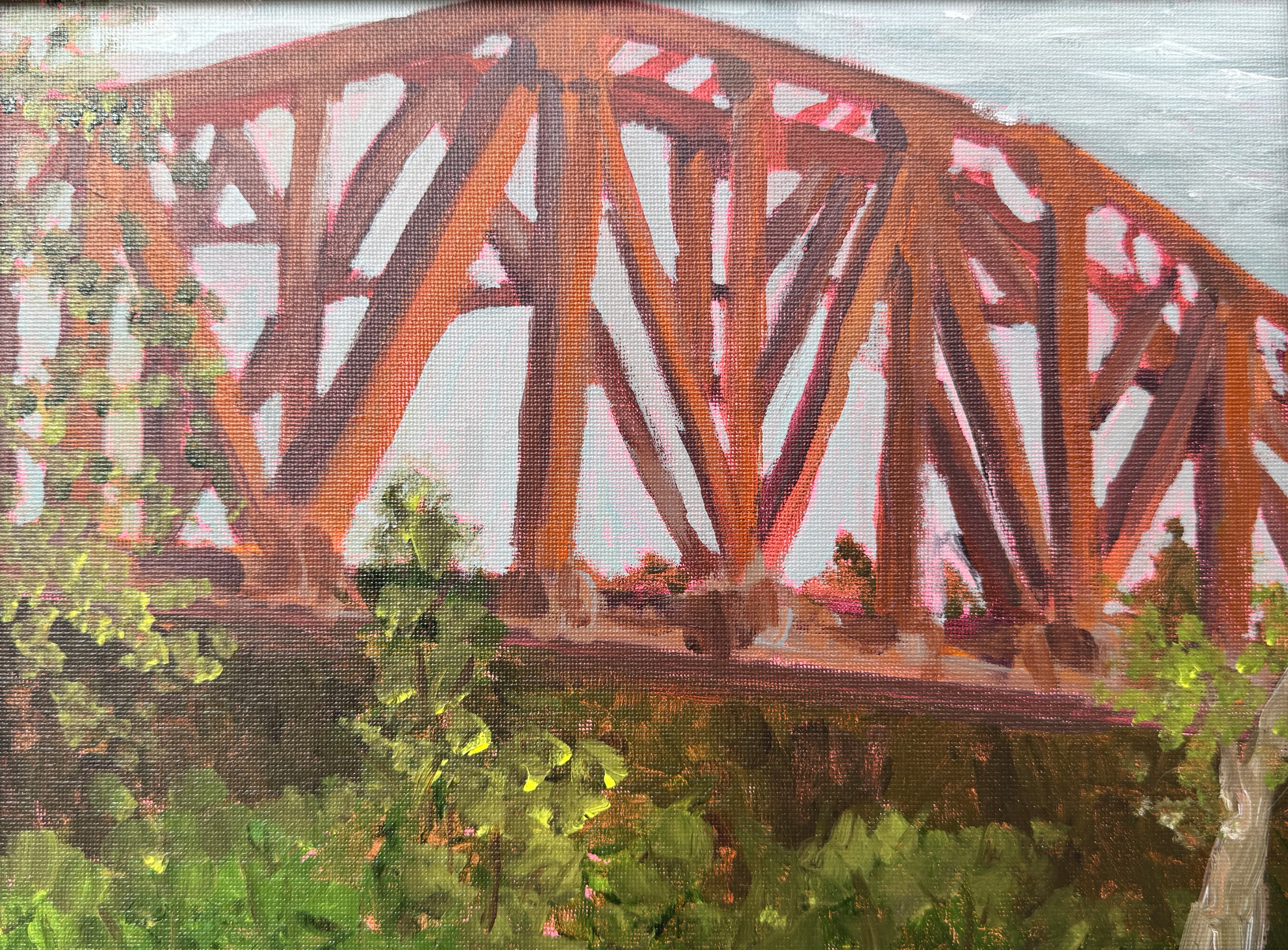 Painting of a wooden bridge with greenery in the background, framed in brown.