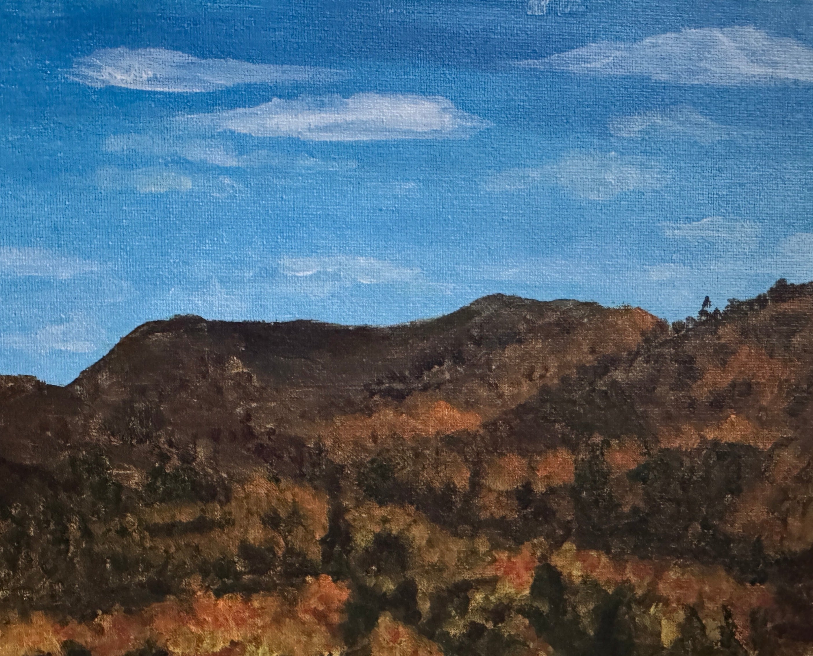 Painting of a landscape with mountains and trees on a stone surface