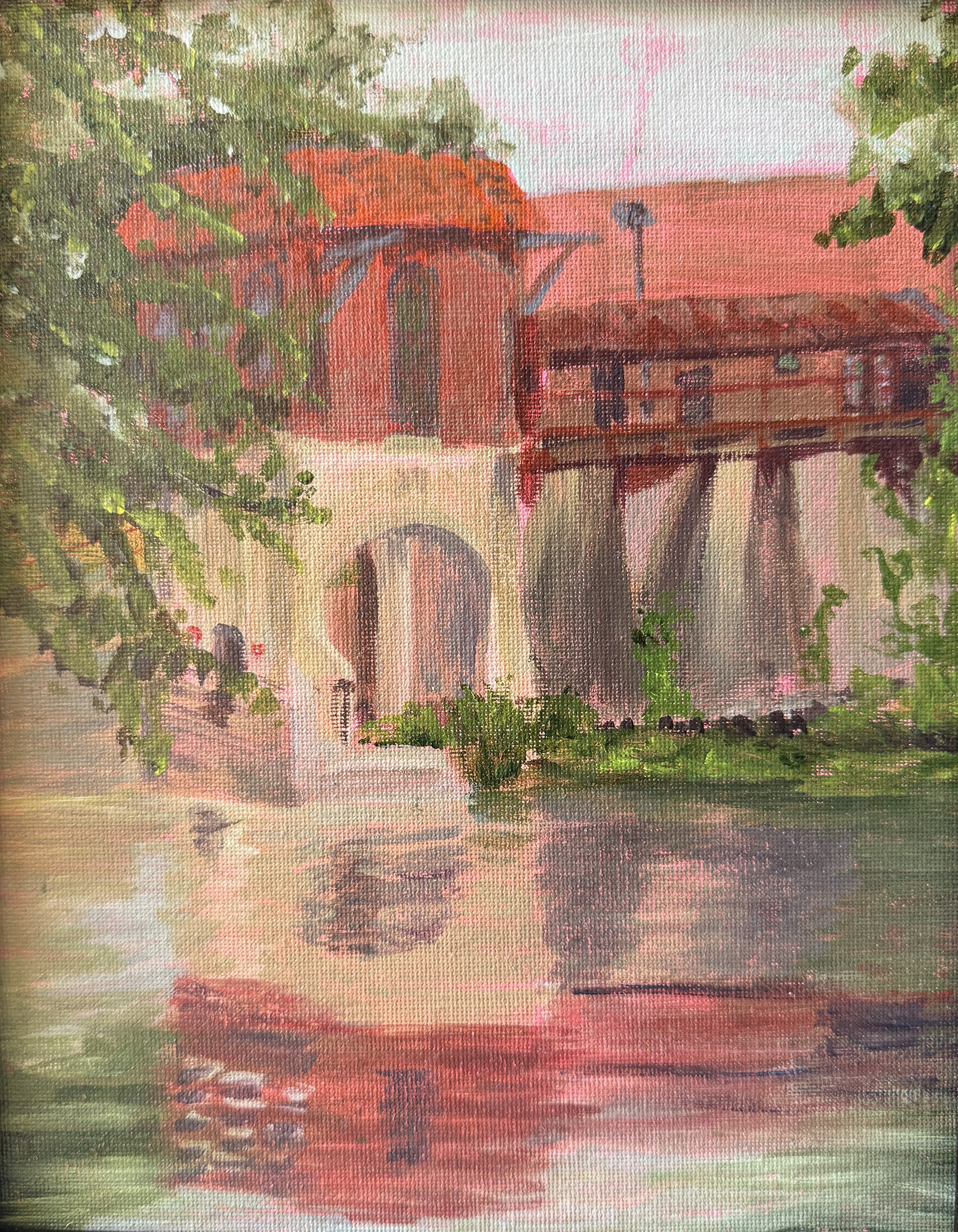 Painting of a covered bridge over a river with trees on either side